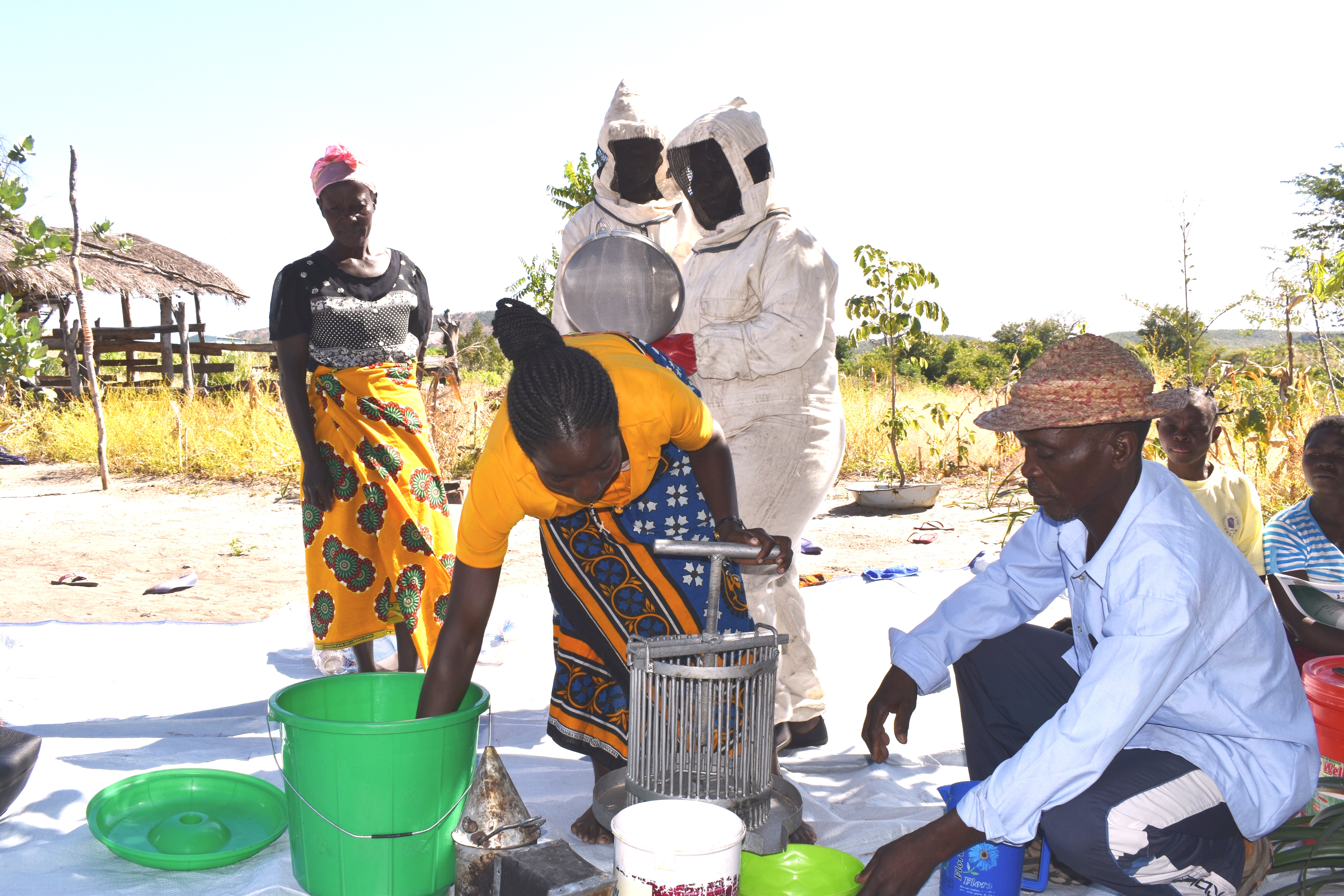 Members of the Dikeni Beekeeping Club learn how to extract honey using a centrifugal honey extractor.